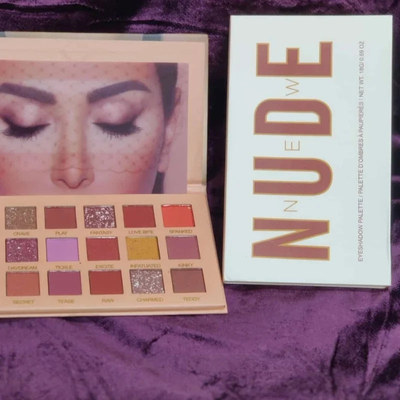 Nude eyeshadow palette with packaging on a purple fabric background