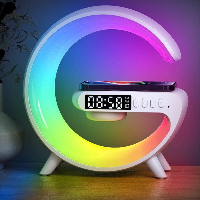 Colorful crescent-shaped night light with digital clock on a wooden surface.