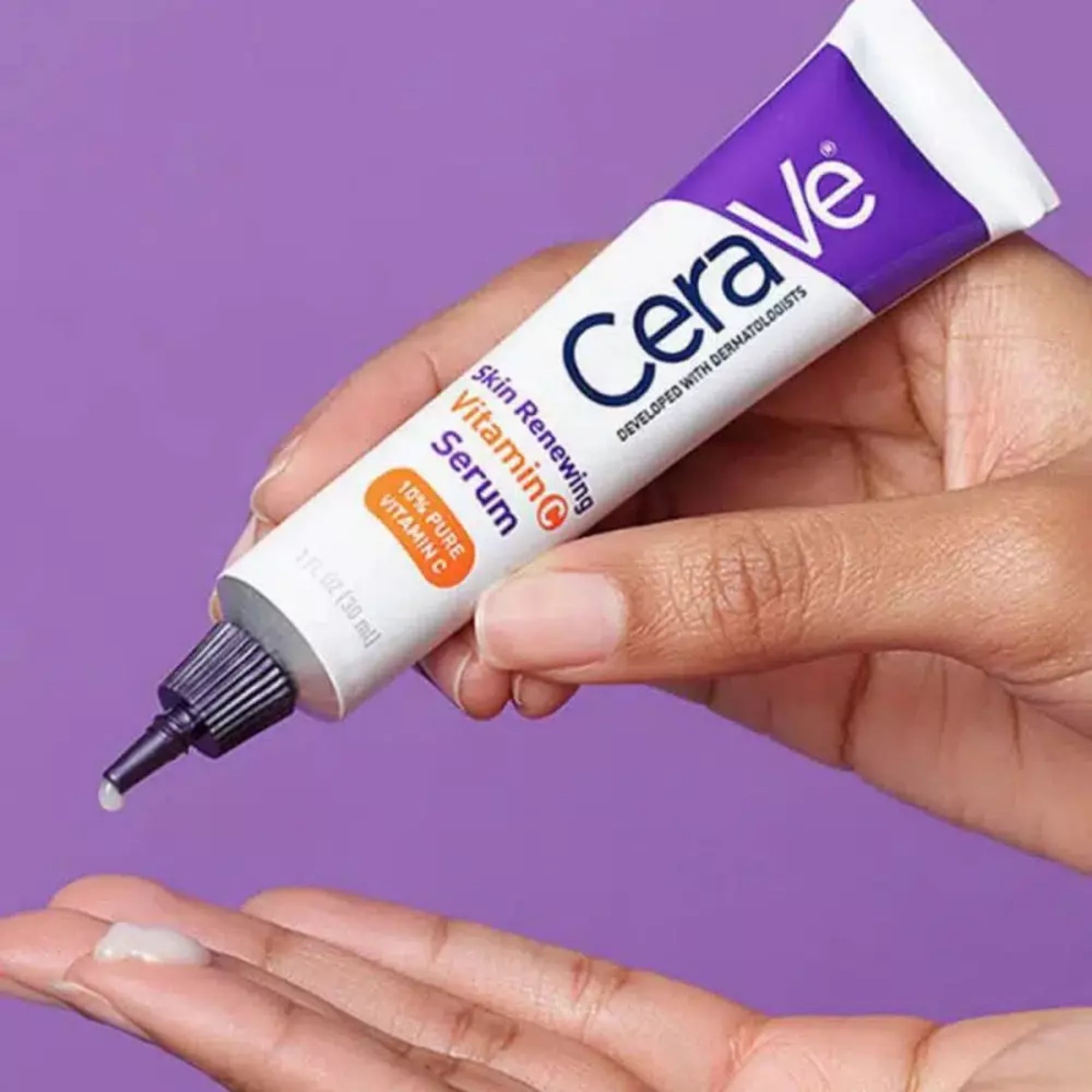 CeraVe skin renewing serum being applied to a hand against a purple background