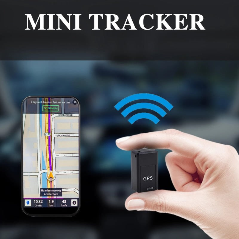 Hand holding a small GPS tracker with smartphone displaying map app in the background