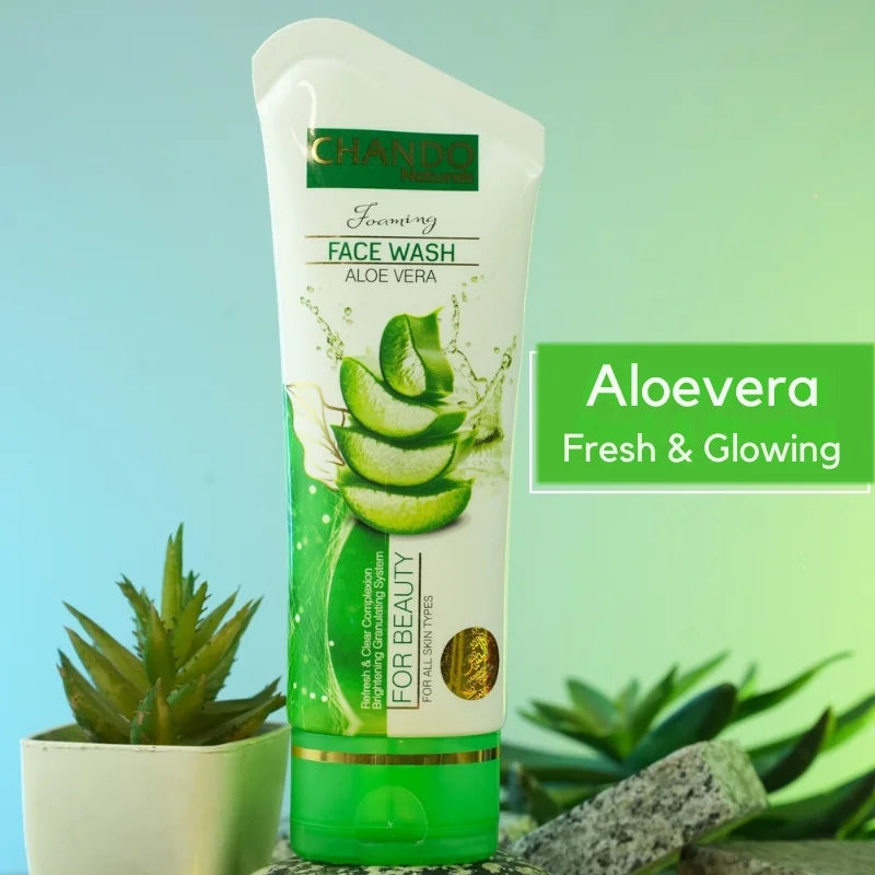 Tube of aloe vera face wash with aloe vera leaves on a green background