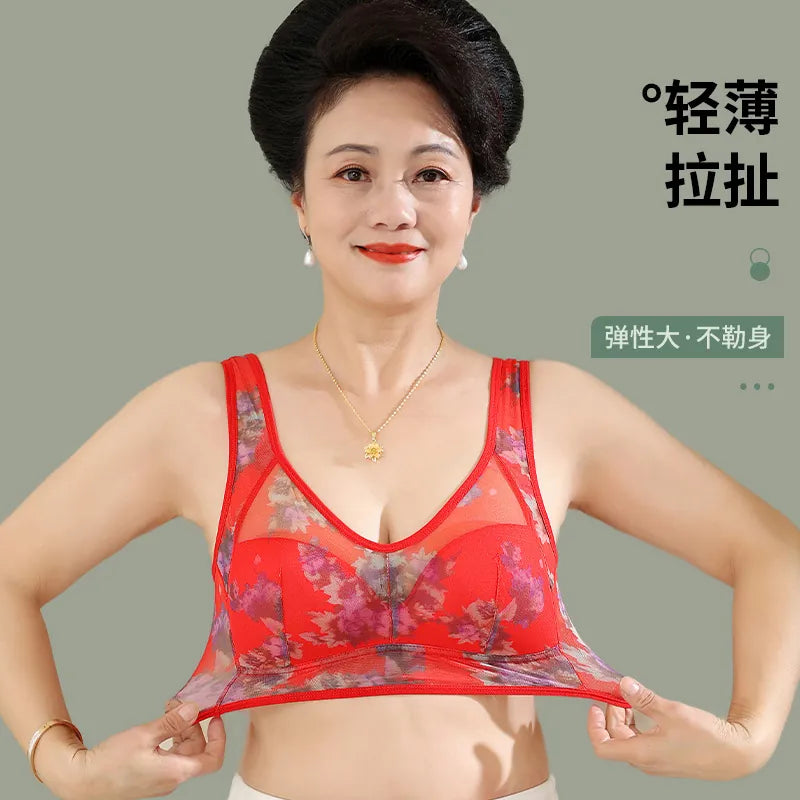 Woman wearing a red floral bra against a plain background