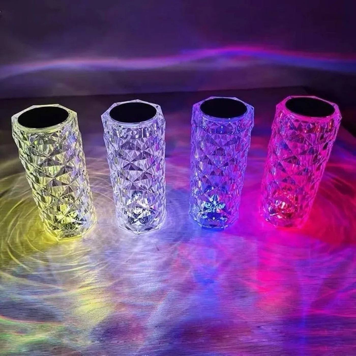 Four colorful LED cups on a reflective surface with a vibrant background