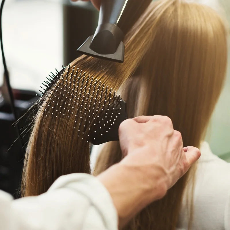Person using a hairbrush on another person's hair