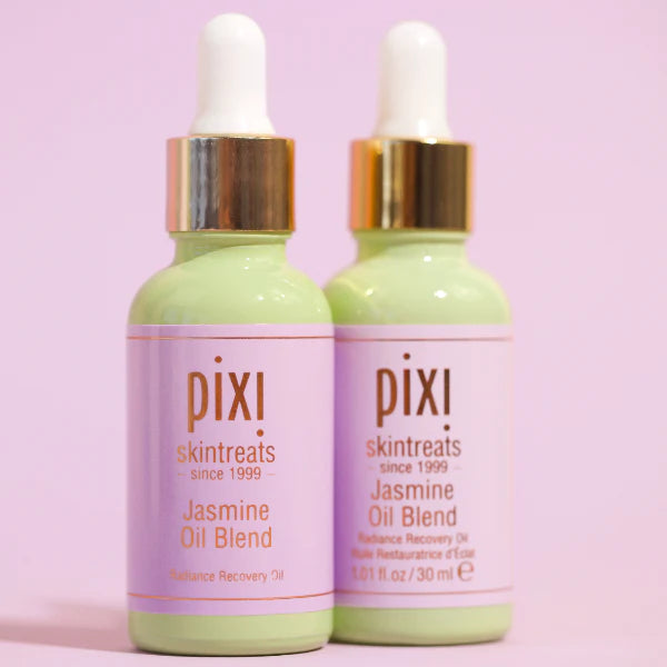 Two bottles of PIXI Jasmine Oil Blend on a pink background