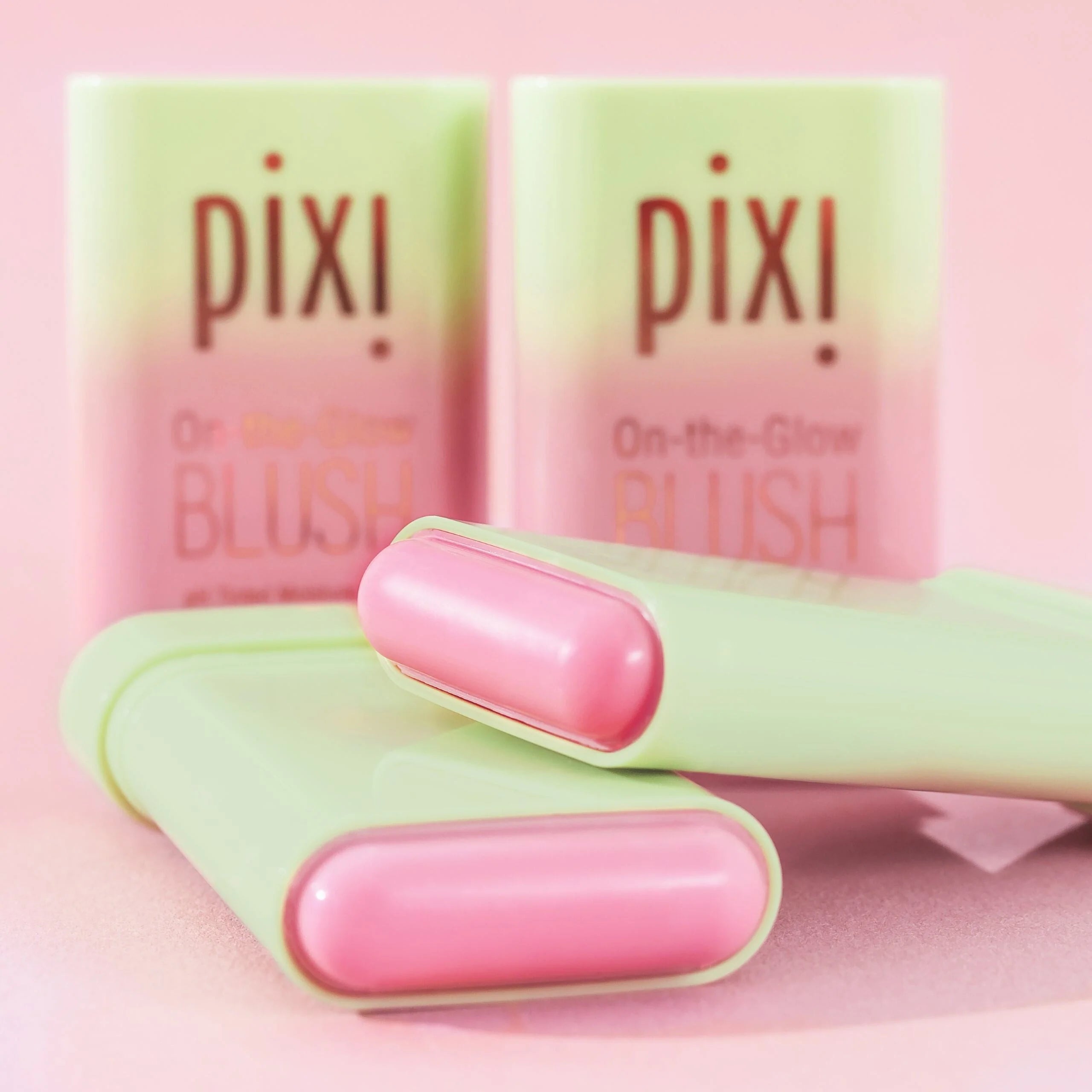 Pixi blush with pink and green packaging on a pink background