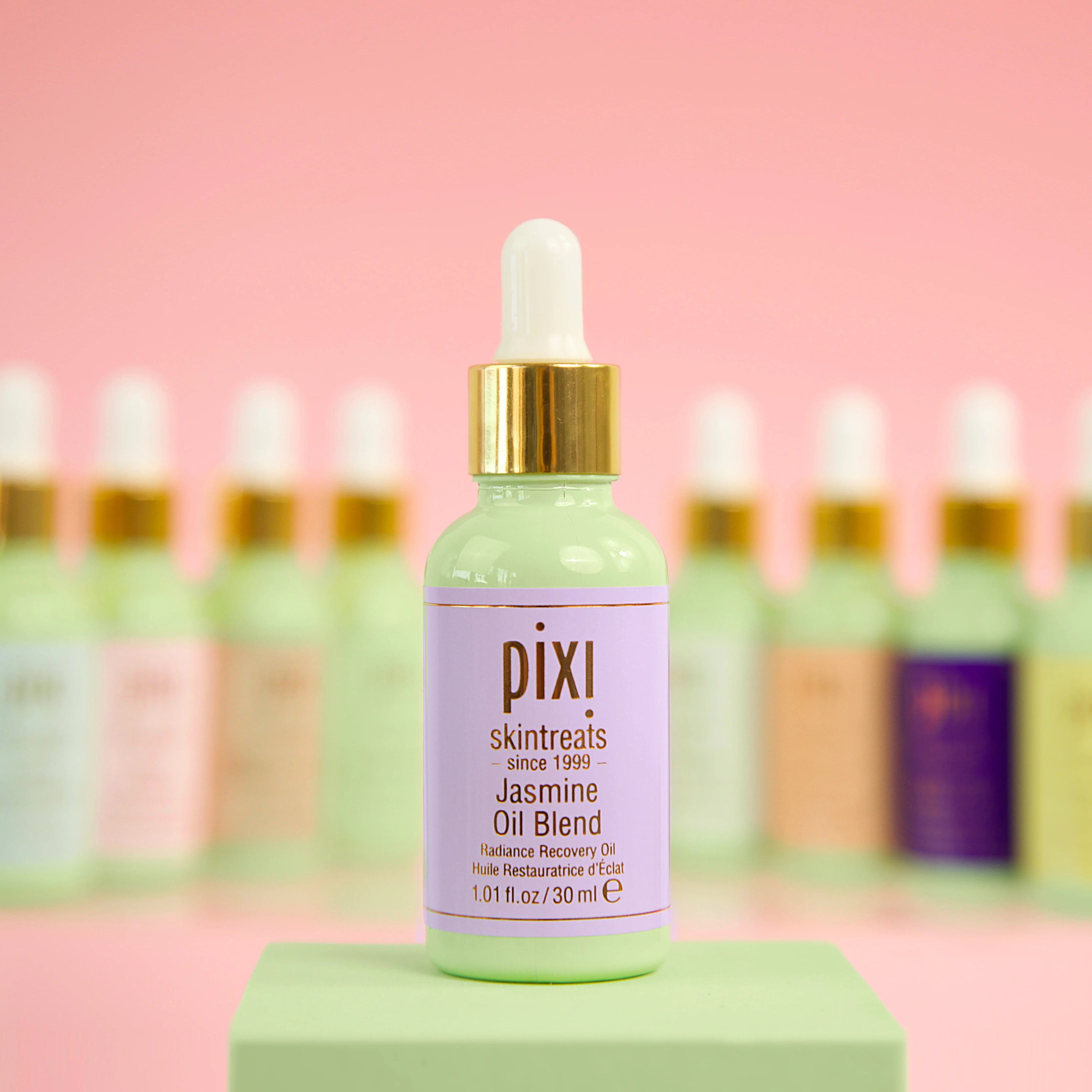 Pixi skincare bottle with dropper on a pink background