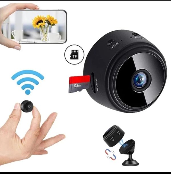 Small black camera with smartphone display, wireless signal icon, and hand holding the camera.